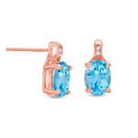 Oval Blue Topaz and Diamond Accent Stud Earrings in Sterling Silver with 14K Rose Gold Plate