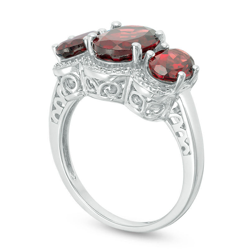 Oval Garnet and Natural Diamond Accent Three Stone Frame Ring in Sterling Silver