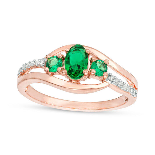 Oval Lab-Created Emerald and 0.05 CT. T.W. Diamond Three Stone Bypass Engagement Ring in Solid 10K Rose Gold