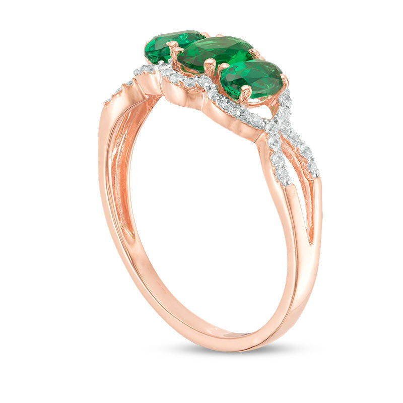 Oval Lab-Created Emerald and 0.17 CT. T.W. Diamond Frame Three Stone Engagement Ring in Solid 10K Rose Gold