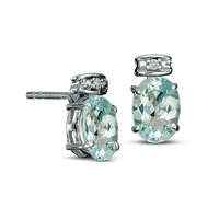 Oval Blue Topaz and Diamond Accent Stud Earrings in Sterling Silver