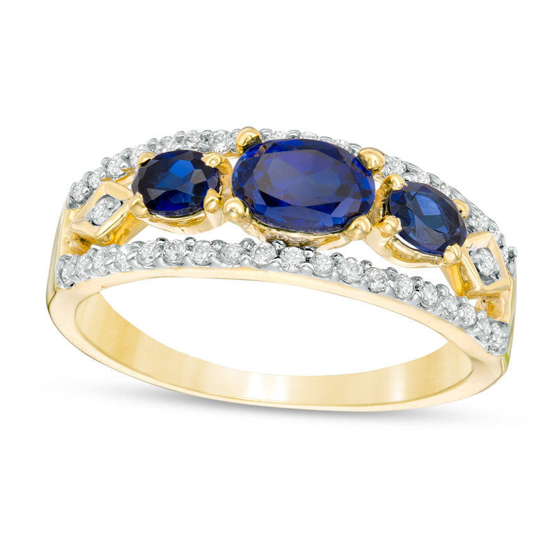 Sideways Oval Lab-Created Blue Sapphire and 0.25 CT. T.W. Diamond Three Stone Ring in Solid 10K Yellow Gold