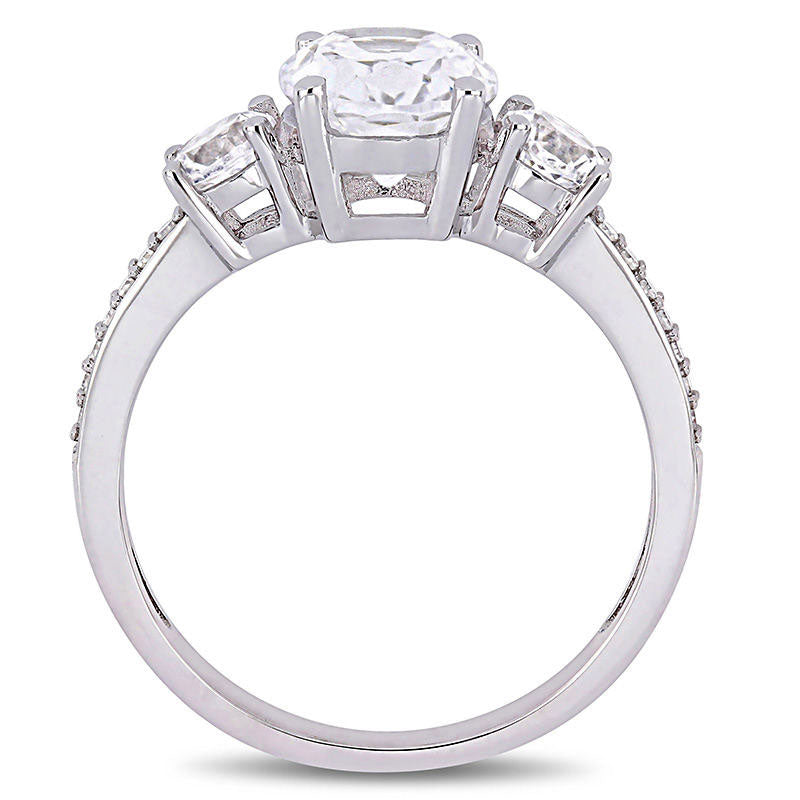 Oval Lab-Created White Sapphire and 0.07 CT. T.W. Diamond Three Stone Engagement Ring in Solid 10K White Gold