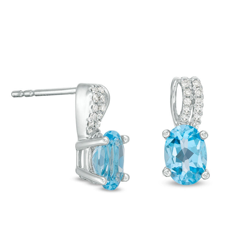 Oval Blue Topaz and 0.07 CT. T.W. Diamond Drop Earrings in 10K White Gold