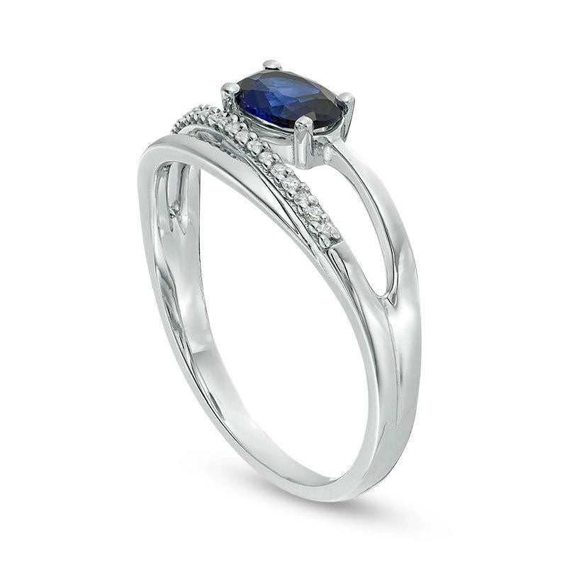 Sideways Oval Lab-Created Blue Sapphire and 0.05 CT. T.W. Diamond Crossover Ribbon Promise Ring in Sterling Silver