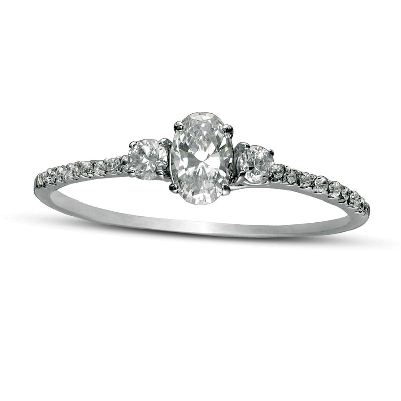 0.63 CT. T.W. Oval and Round Natural Diamond Three Stone Engagement Ring in Solid 14K White Gold