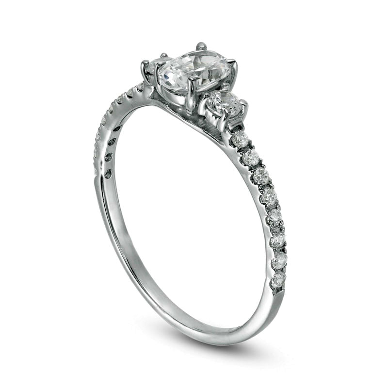 0.88 CT. T.W. Oval and Round Natural Diamond Three Stone Engagement Ring in Solid 14K White Gold