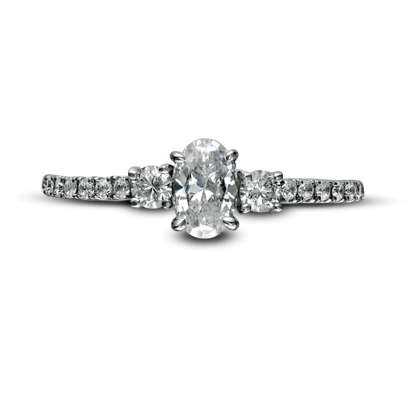 0.88 CT. T.W. Oval and Round Natural Diamond Three Stone Engagement Ring in Solid 14K White Gold