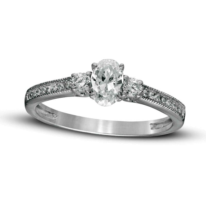 0.63 CT. T.W. Oval and Round Natural Diamond Three Stone Engagement Ring in Solid 14K White Gold