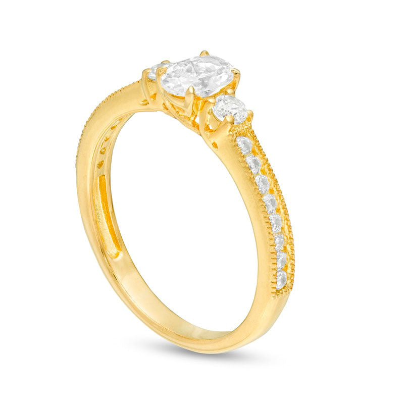 0.88 CT. T.W. Oval and Round Natural Diamond Three Stone Engagement Ring in Solid 14K Gold