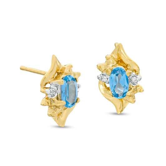 Oval Lab-Created Blue Zircon and Diamond Accent Flame Stud Earrings in 10K Gold