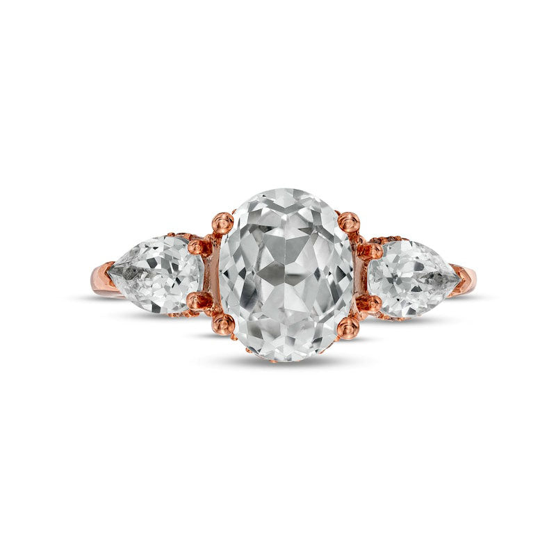 Oval White Lab-Created Sapphire and 0.17 CT. T.W. Diamond Frame Three Stone Engagement Ring in Solid 10K Rose Gold