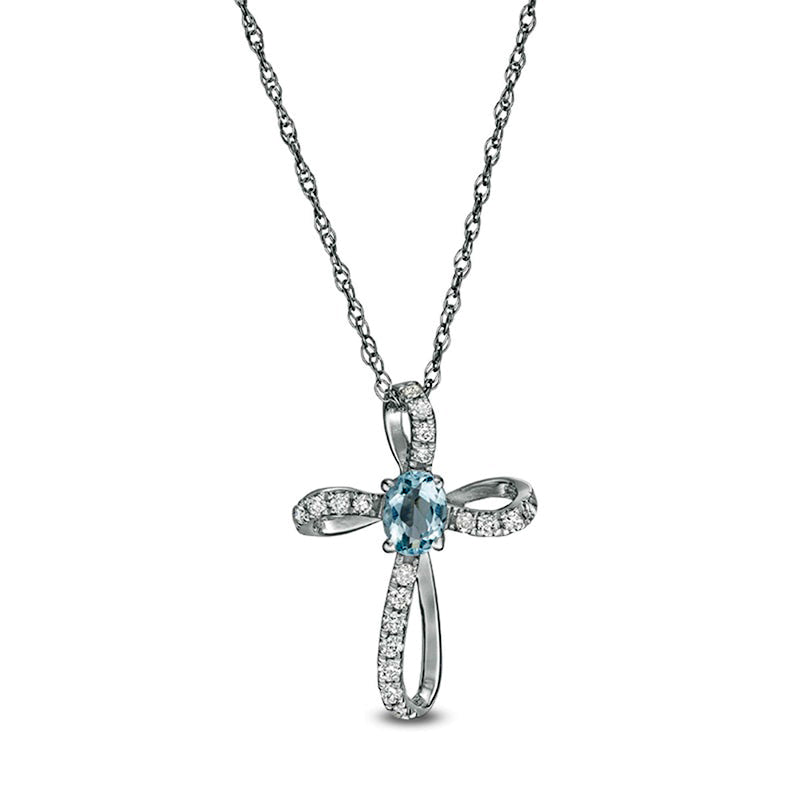 Oval Aquamarine and 0.1 CT. T.W. Natural Diamond Pinwheel Cross Pendant in 10K White Gold