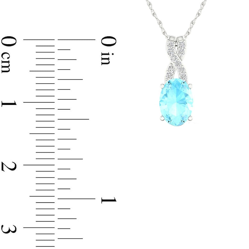 Oval Aquamarine and 0.05 CT. T.W. Natural Diamond "X" Drop Pendant in 10K White Gold