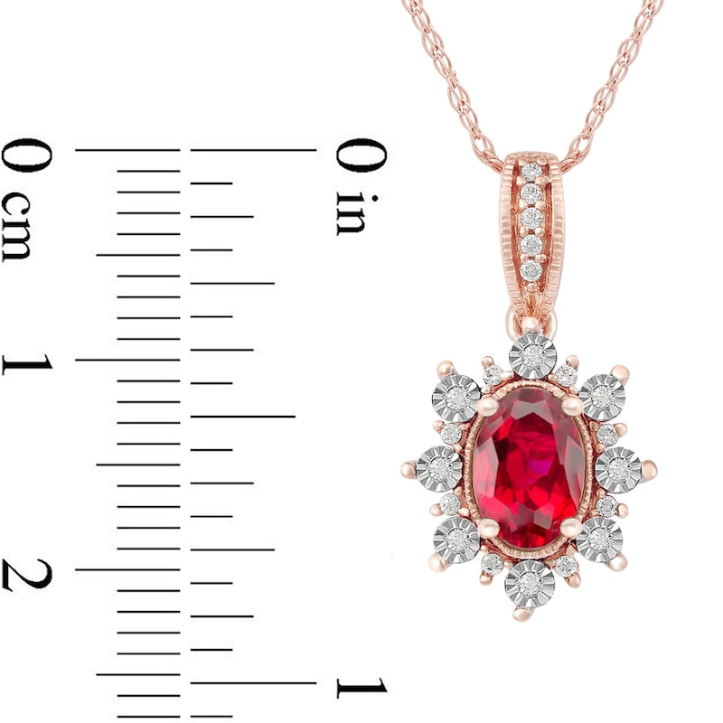 Oval Ruby and 0.07 CT. T.W. Natural Diamond Sunburst Frame Antique Vintage-Style Drop Pendant in 10K Rose Gold