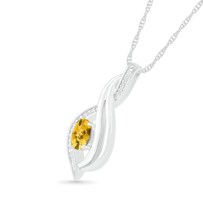 Oval Citrine and 0.05 CT. T.W. Natural Diamond Flame Drop Pendant in Sterling Silver