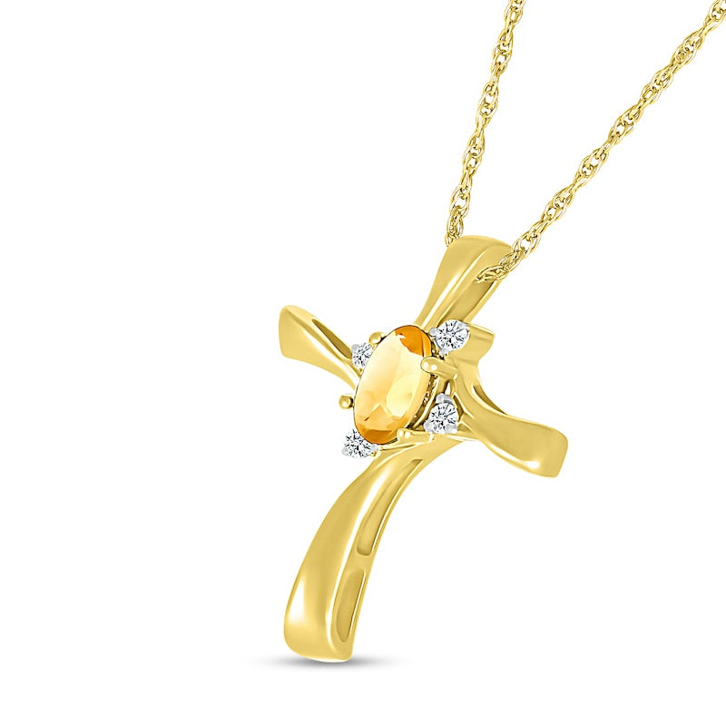 Oval Citrine and Natural Diamond Accent Swirl Ribbon Cross Pendant in 10K Yellow Gold