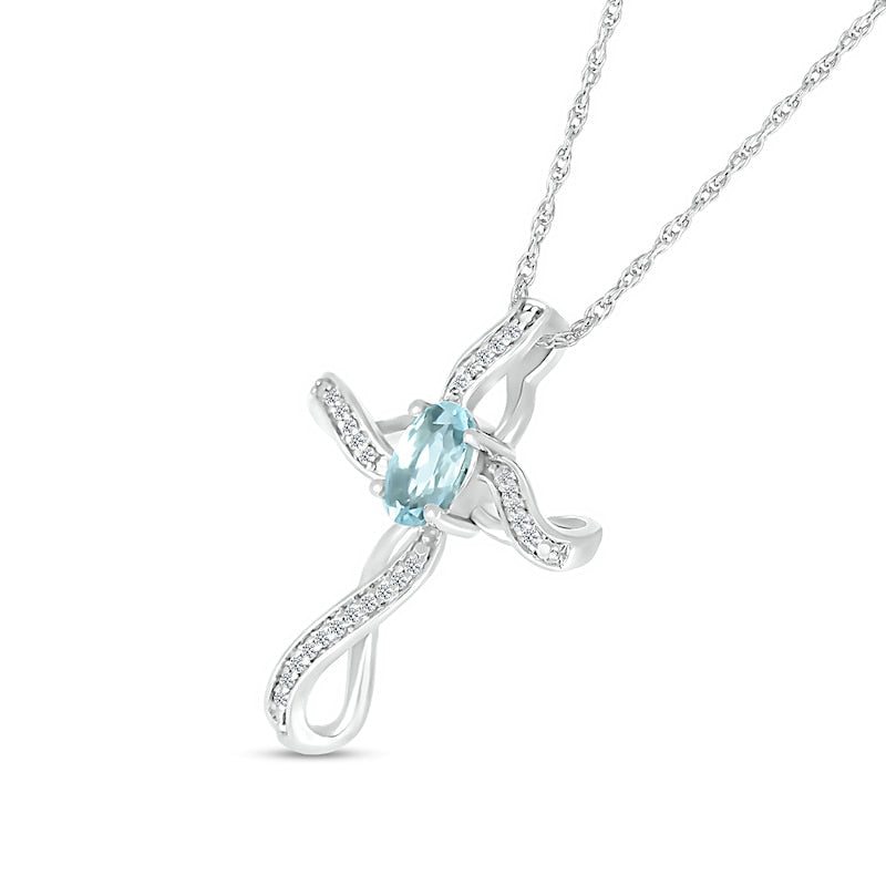 Oval Aquamarine and 0.05 CT. T.W. Natural Diamond Infinity Ribbon Cross Pendant in 10K White Gold