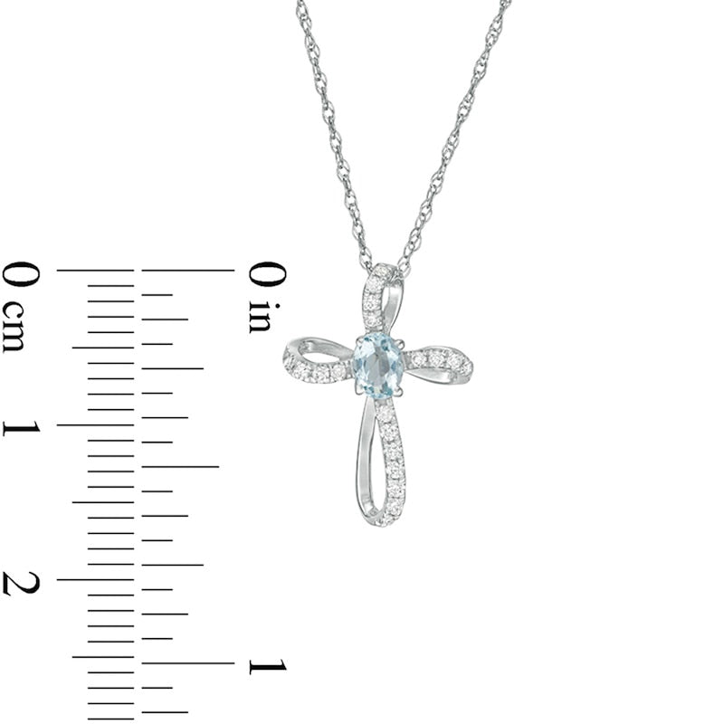 Oval Aquamarine and 0.1 CT. T.W. Natural Diamond Pinwheel Cross Pendant in 10K White Gold